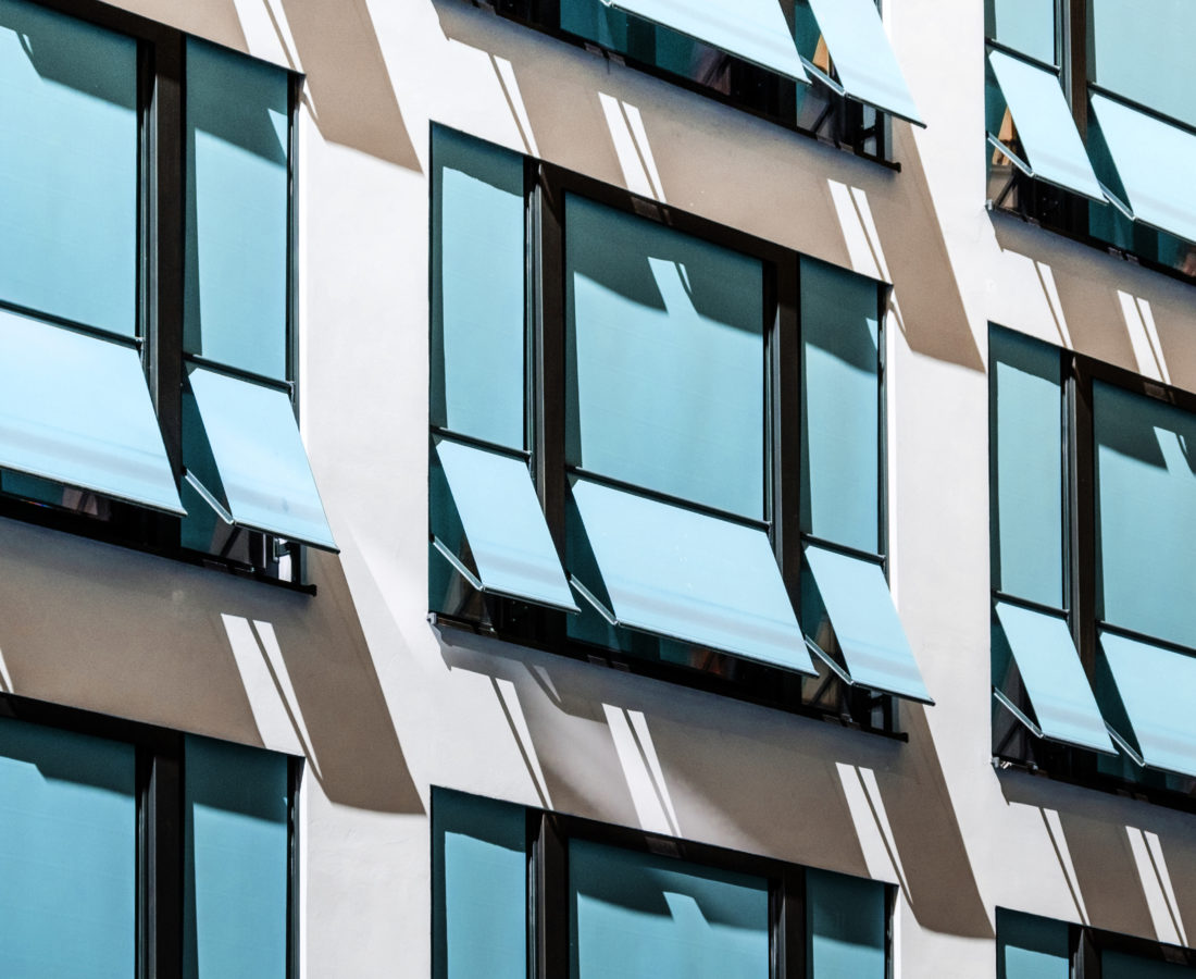 closed  sun blinds on building facade , modern sunshades / awnings
